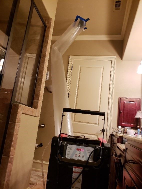 Dehumidified air being forced into ceiling cavity Dehumidified air being forced into ceiling cavity