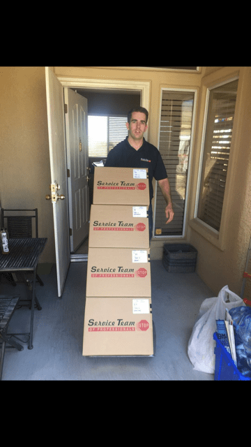 Technician hauling boxes