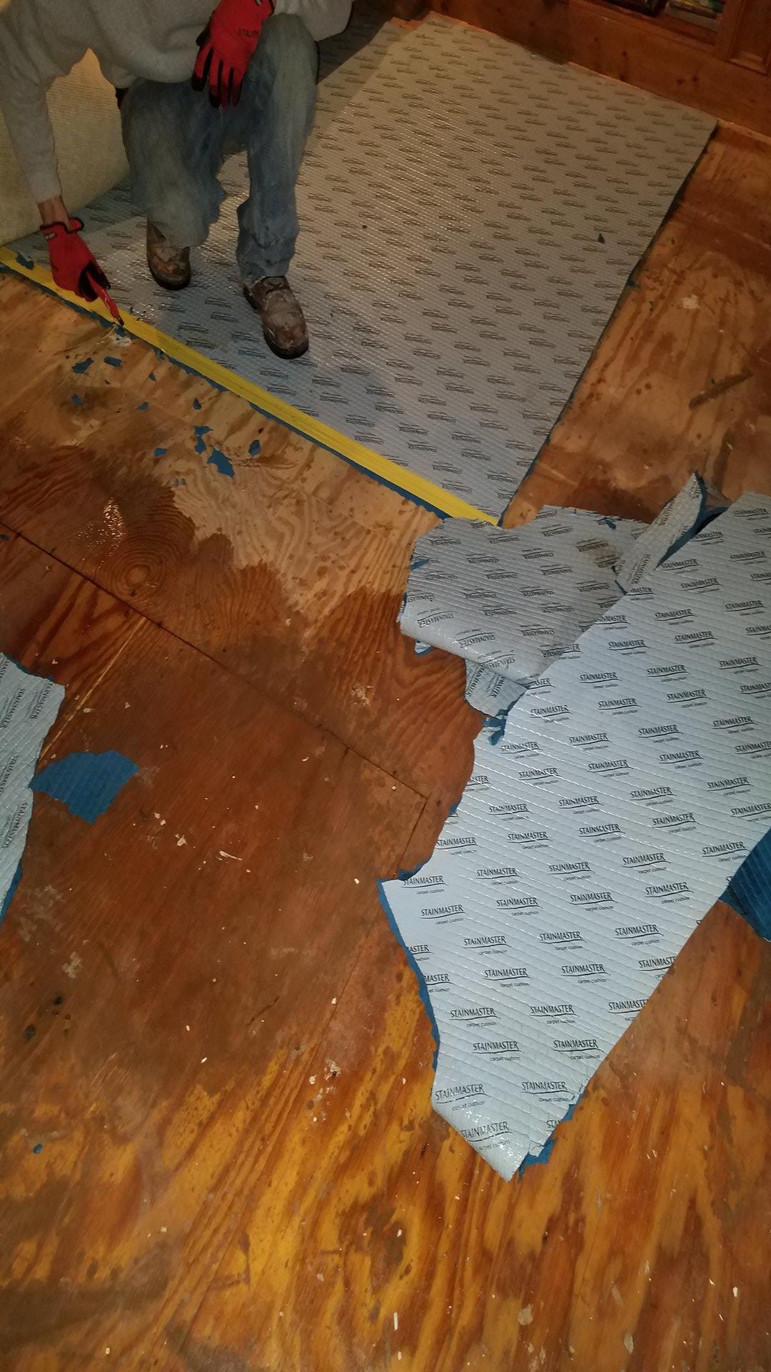 Employee repairing floor tiles