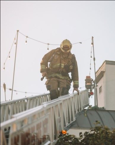 Firefighter on Raised Ladder