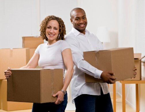 Man and Woman Holding Moving Boxes